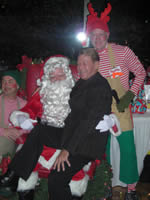Bradford McIntyre, BCPWA Member since 1995, with Santa Claus and his Helpers, at the British Columbia Persons with AIDS Society (BCPWA) Members Holiday Season Dinner, December 11, 2009. Vancouver, BC, Canada