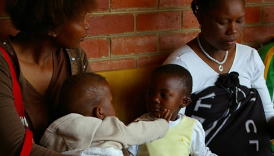 Mothers with babies waiting for an HIV education session at a clinic in Lesotho, Southern Africa. Male infants infected with HIV during pregnancy are more likely than girls to achieve sustained HIV remission after receiving treatment, researchers say. Copyright: Courtesy of kommanderkat (CC BY-NC 2.0).