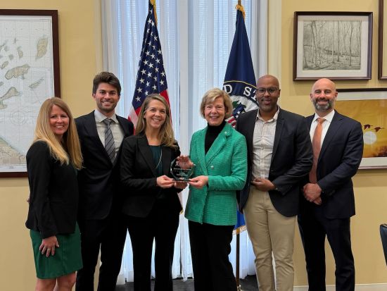 Sen. Tammy Baldwin, center, receives an inaugural Champion Award from the U.S. Business Action to End HIV