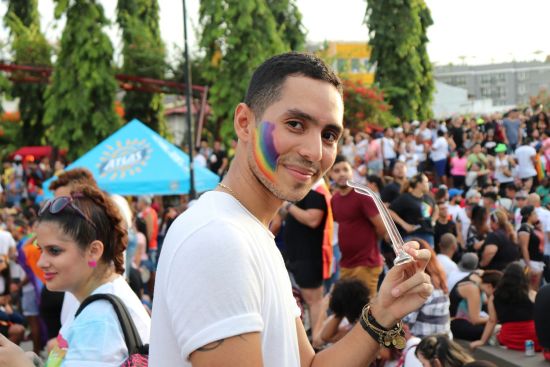 A man at a Pride parade. Photo by Betzy Arosemena for Unspalsh