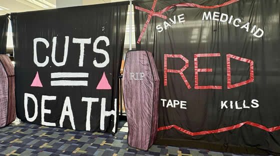 A black sheet with the messages cuts=death and Red Tape Kills