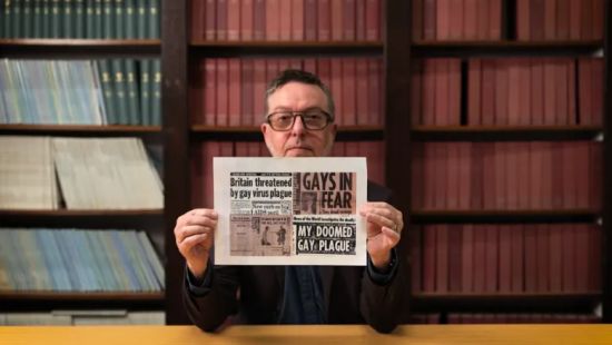 Richard holding newspaper clipping